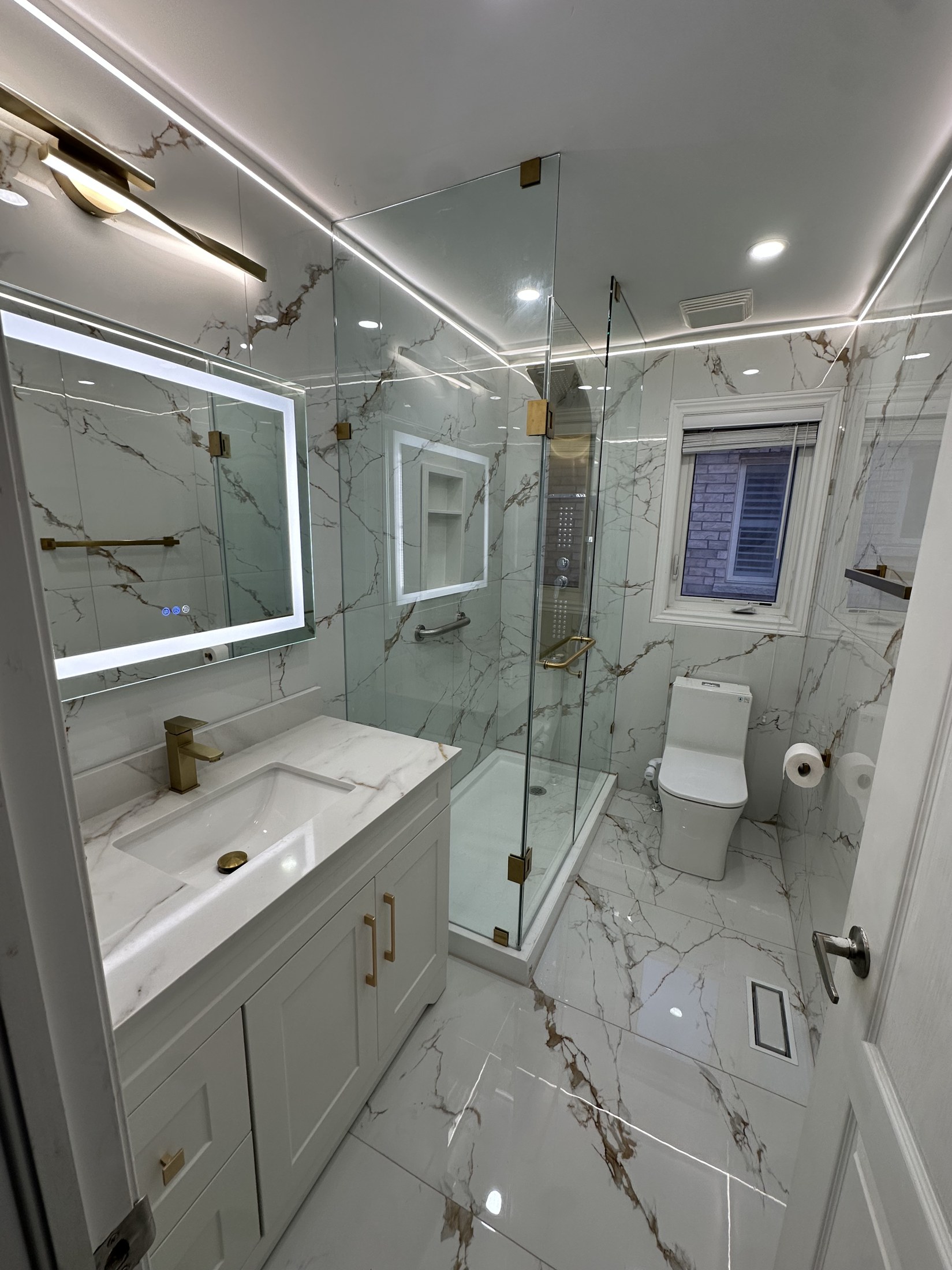 Frameless Glass Shower & Brass Fixtures — Renovations project by Redstone Construction in Brampton, ON