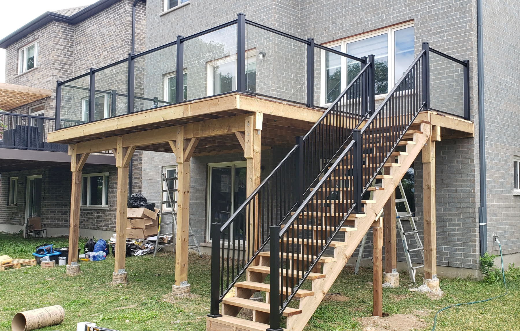 Elevated glass-rail cedar deck built by Redstone Construction & Builders in Brampton, Ontario
